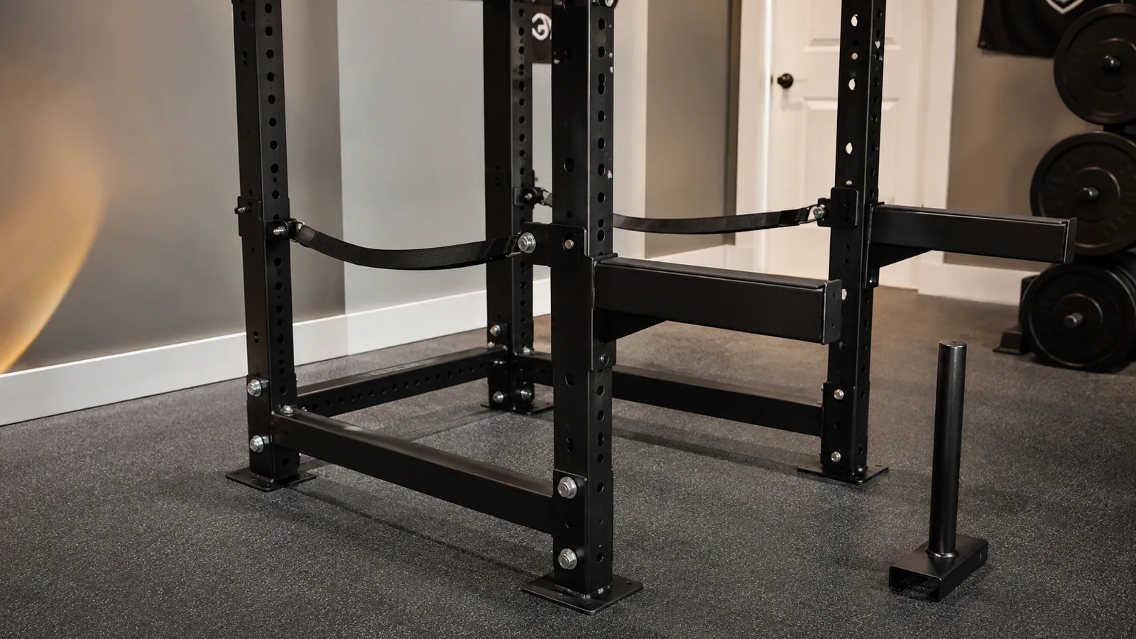 Power rack displaying a safety strap, pin-pipe safety and padded spotter arm at separate heights